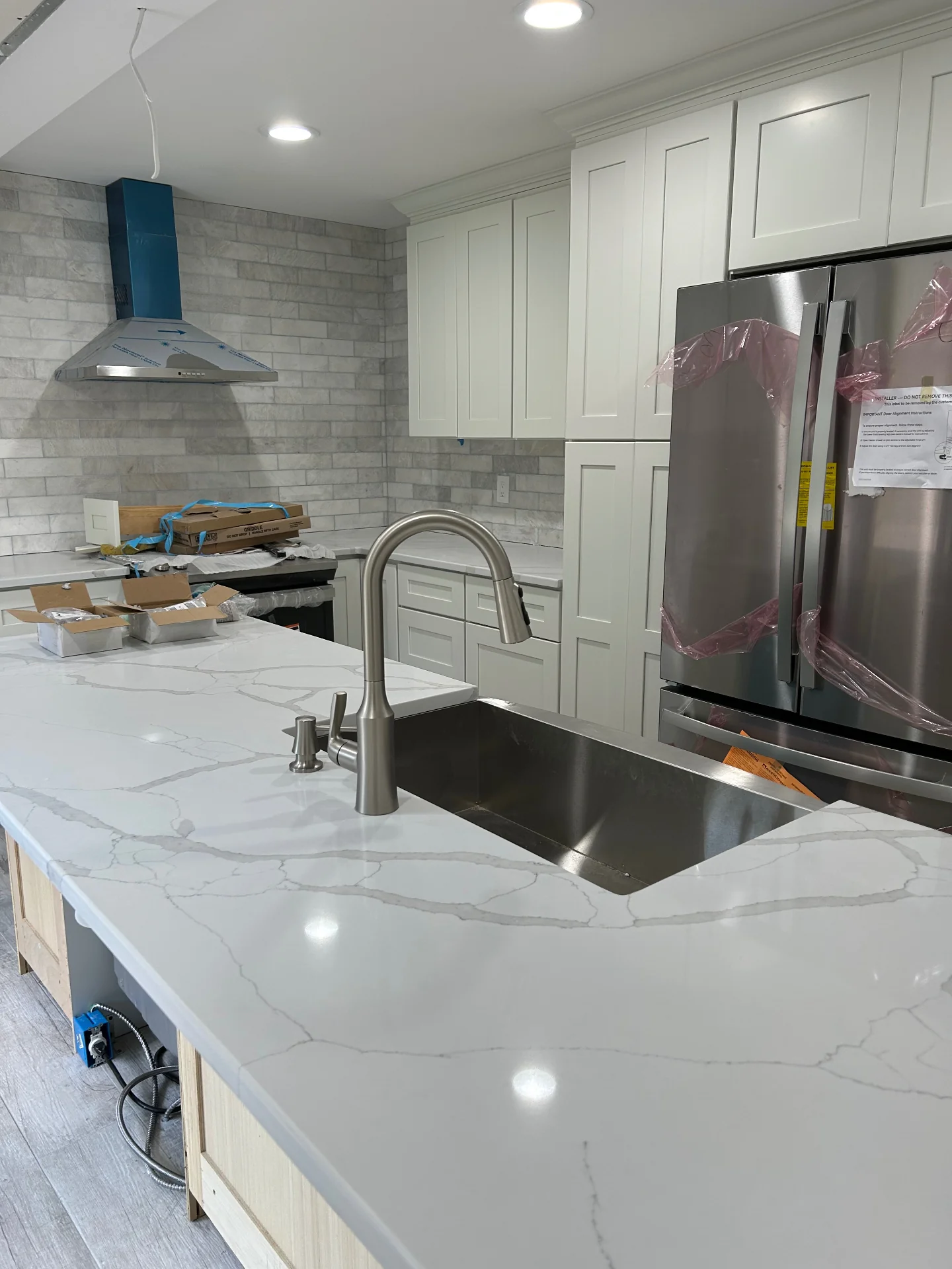 Luxury custom kitchen with waterfall quartz island and premium cabinetry in Bergen County NJ by Strong Construction