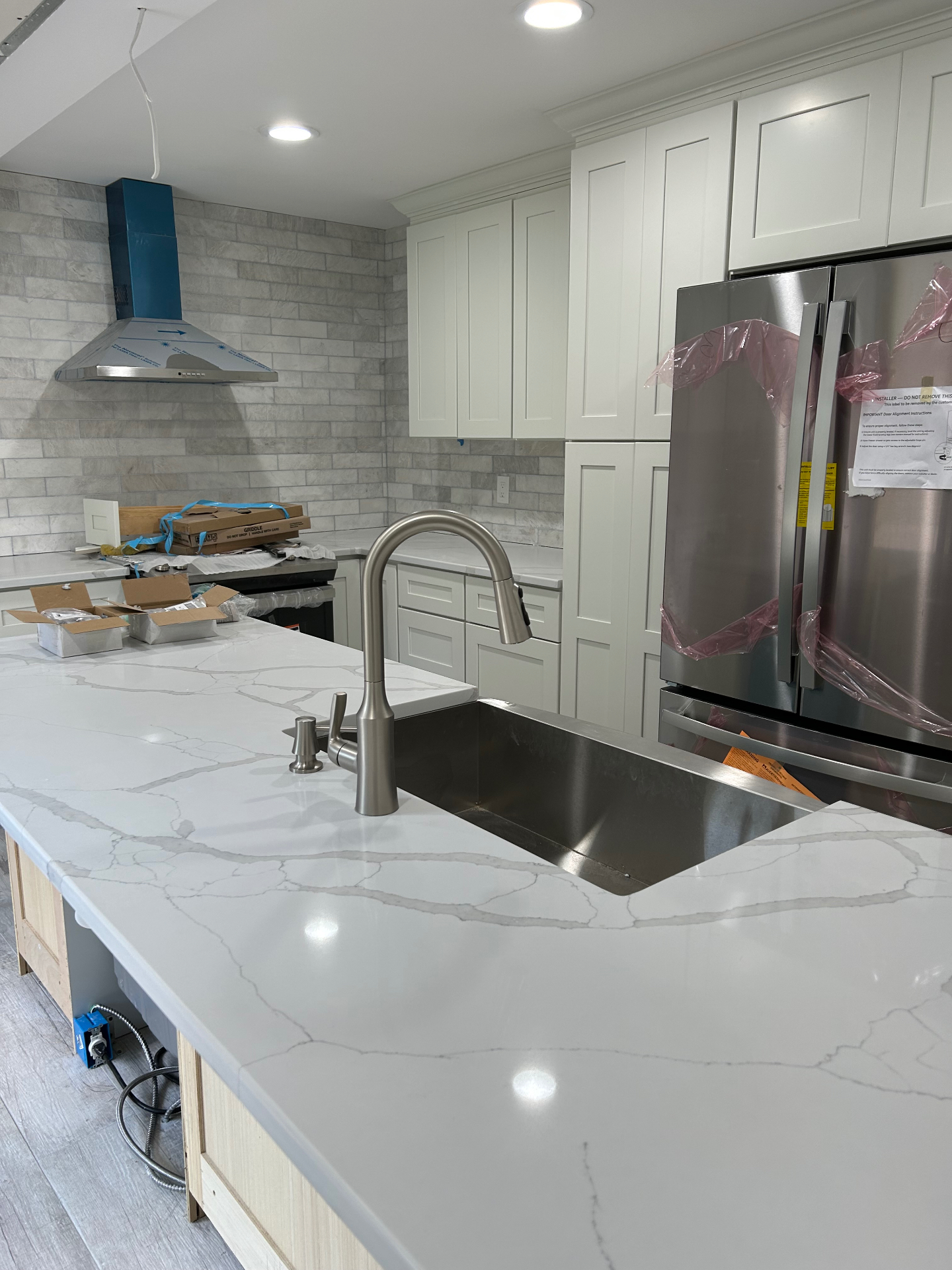 Luxury custom kitchen with waterfall quartz island and premium cabinetry in Bergen County NJ by Strong Construction